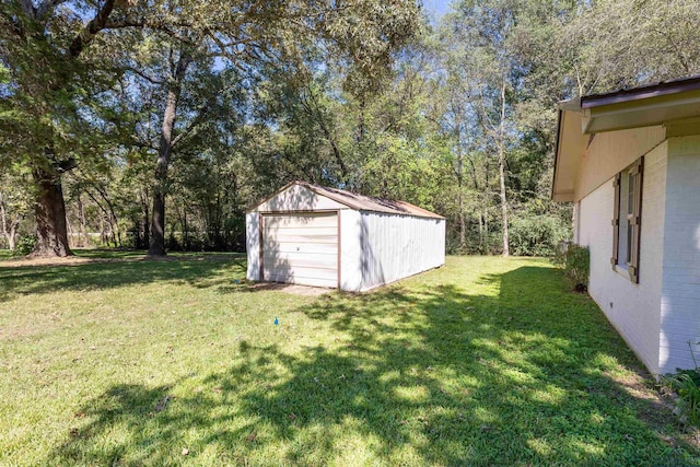 view of yard with a garage and an outdoor structure