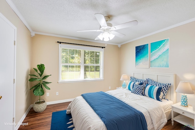 bedroom with a textured ceiling, dark wood-type flooring, ceiling fan, and ornamental molding