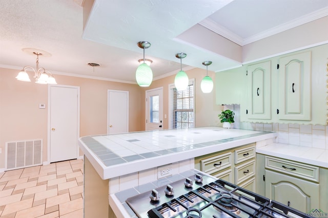 kitchen with kitchen peninsula, an inviting chandelier, crown molding, and light tile patterned flooring