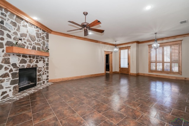 unfurnished living room with ceiling fan with notable chandelier, a stone fireplace, and crown molding