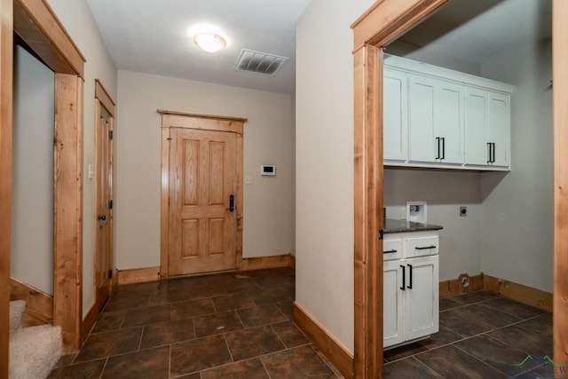 washroom with electric dryer hookup, cabinets, and washer hookup