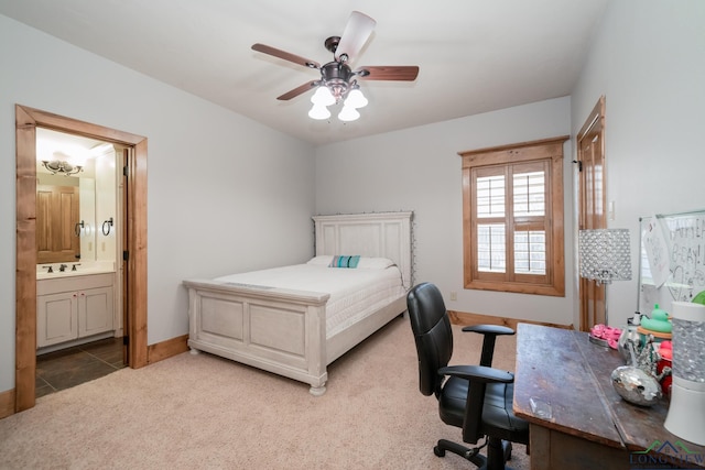 carpeted bedroom with ensuite bath, ceiling fan, and sink