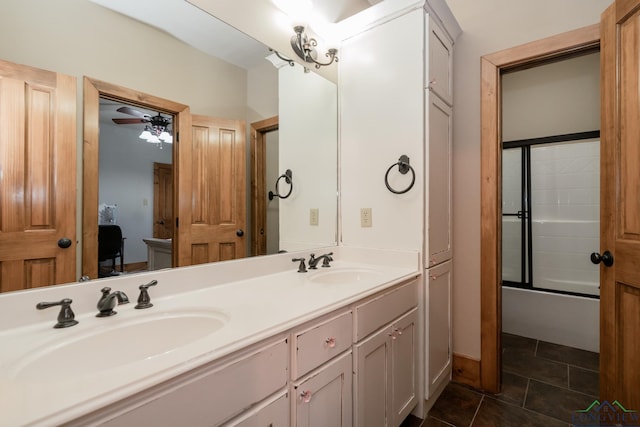 bathroom featuring ceiling fan, tile patterned flooring, vanity, and bath / shower combo with glass door