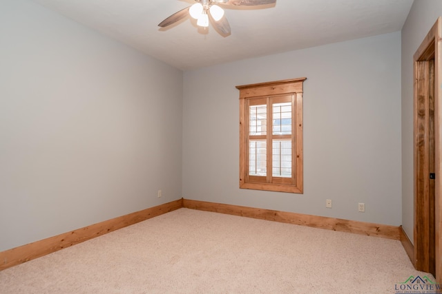 carpeted spare room with ceiling fan