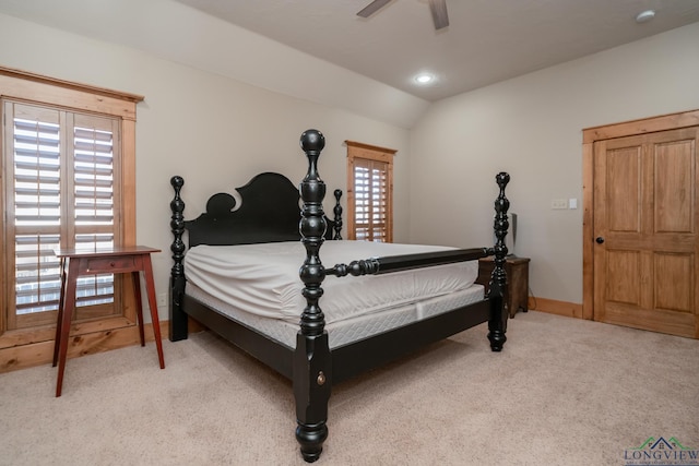 carpeted bedroom with vaulted ceiling and ceiling fan