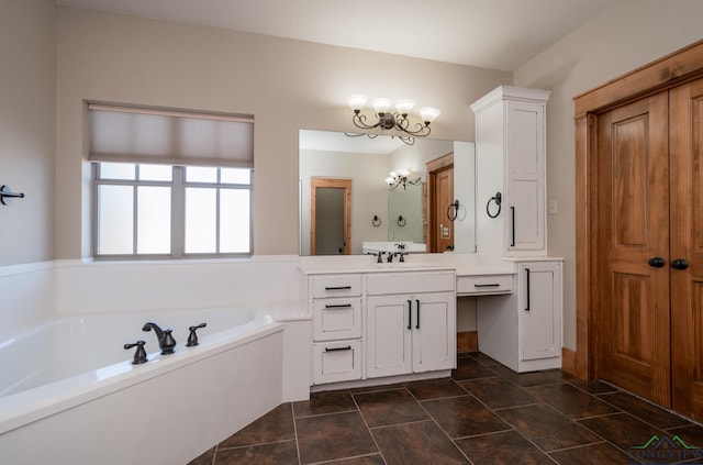 bathroom featuring a washtub, vanity, and a chandelier