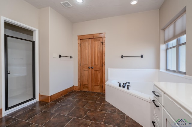 bathroom with vanity and independent shower and bath