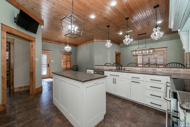 kitchen with white cabinetry, a center island, wooden ceiling, and decorative light fixtures