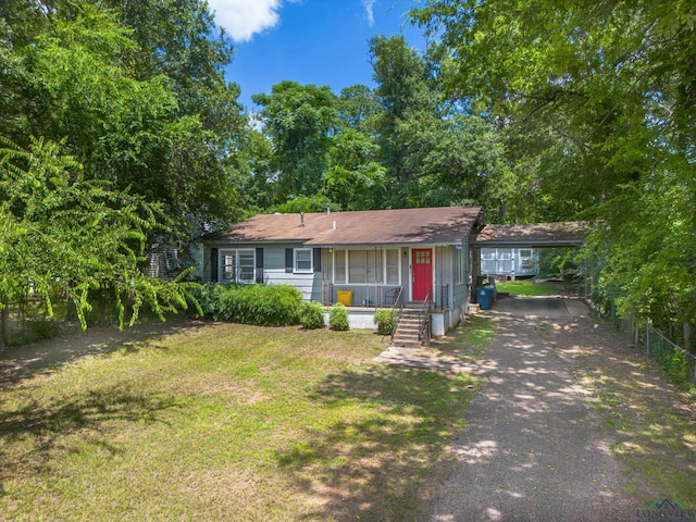 1504 Alice St, Gladewater, TX 75647 - ranch-style home featuring asphalt driveway, a porch, and a front lawn