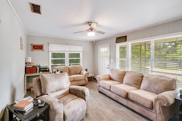 1504 Alice St, Gladewater, TX 75647 - living room with a ceiling fan, wood finished floors, and ornamental molding