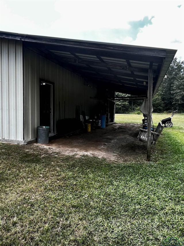 exterior space featuring a carport and a yard