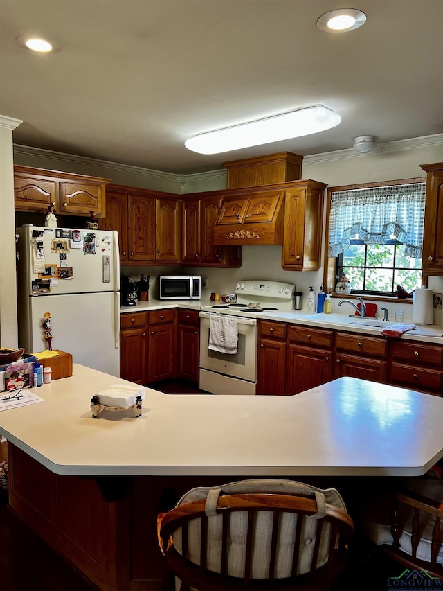 kitchen featuring a center island, white appliances, ornamental molding, custom range hood, and a breakfast bar area