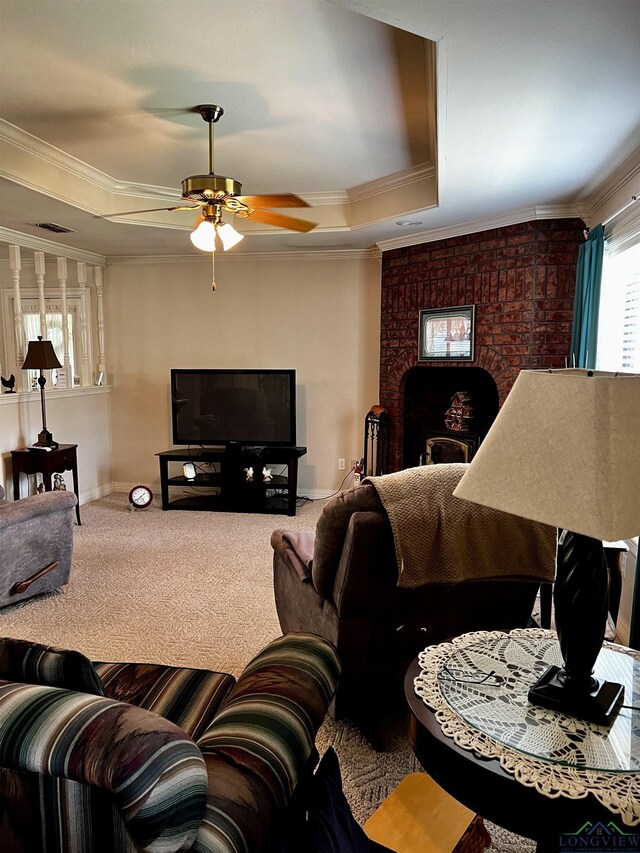 living room with carpet, a raised ceiling, ceiling fan, and ornamental molding