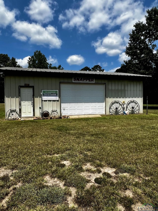 garage featuring a lawn