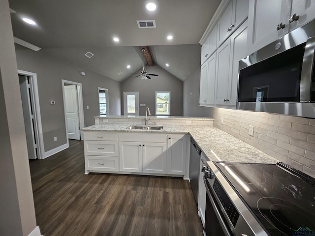 kitchen with stainless steel appliances, white cabinetry, sink, and kitchen peninsula