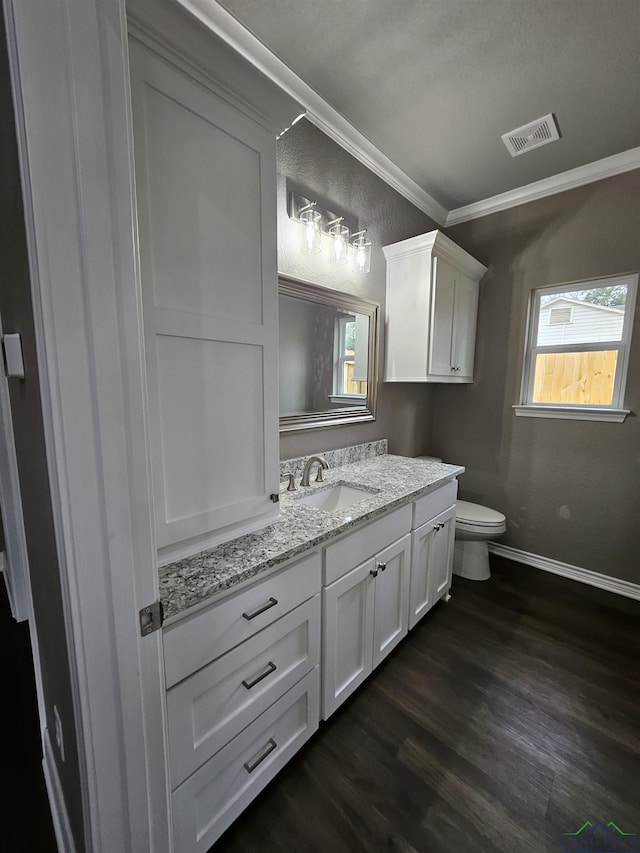 bathroom with crown molding, vanity, toilet, and hardwood / wood-style floors