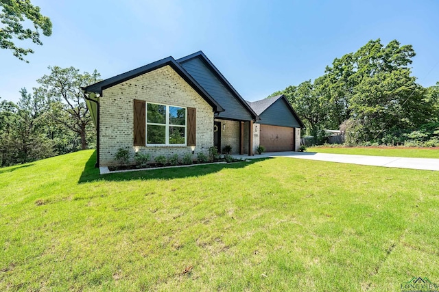 view of front of property with a garage and a front lawn