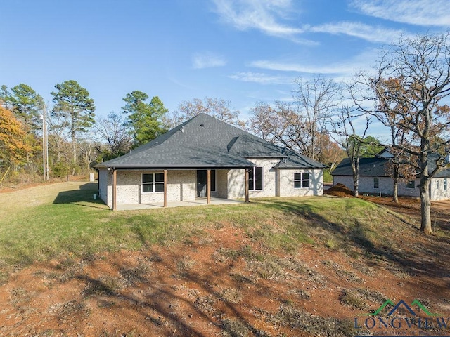 back of property featuring a lawn and a patio area