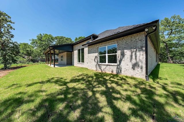 rear view of property with a lawn