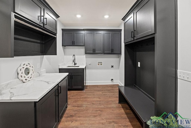 kitchen featuring light stone countertops, sink, and dark wood-type flooring