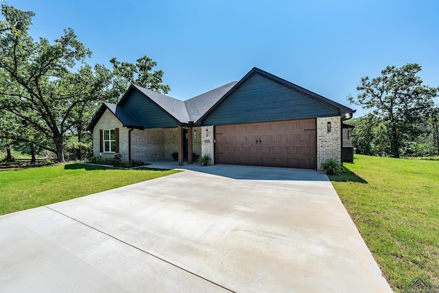 view of front of house with a garage and a front yard