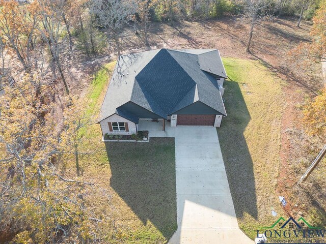 view of front of home with a garage and a front lawn