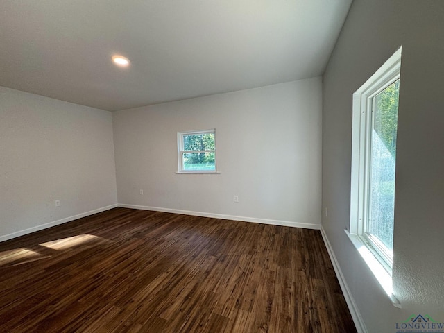 spare room with dark hardwood / wood-style flooring