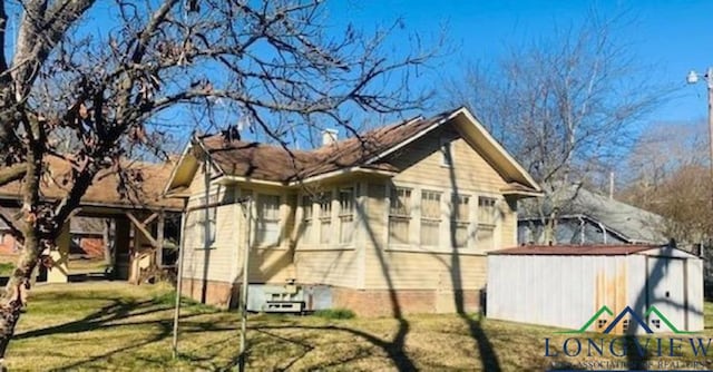 view of property exterior with a lawn