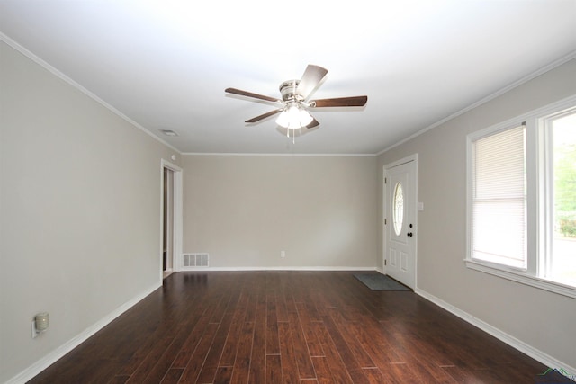 empty room with dark hardwood / wood-style floors, ceiling fan, and crown molding