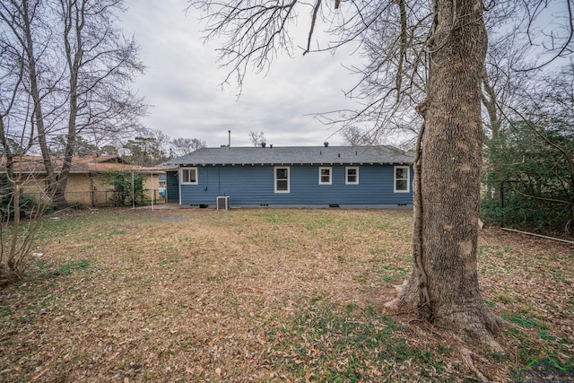 rear view of house featuring crawl space, fence, and a yard