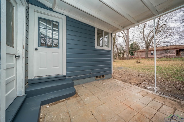 doorway to property with a yard and crawl space