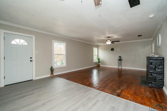 entrance foyer with ceiling fan, baseboards, wood finished floors, and crown molding