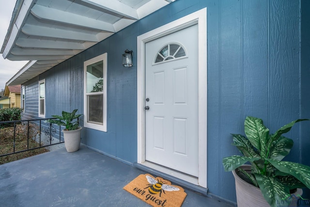 view of exterior entry with covered porch