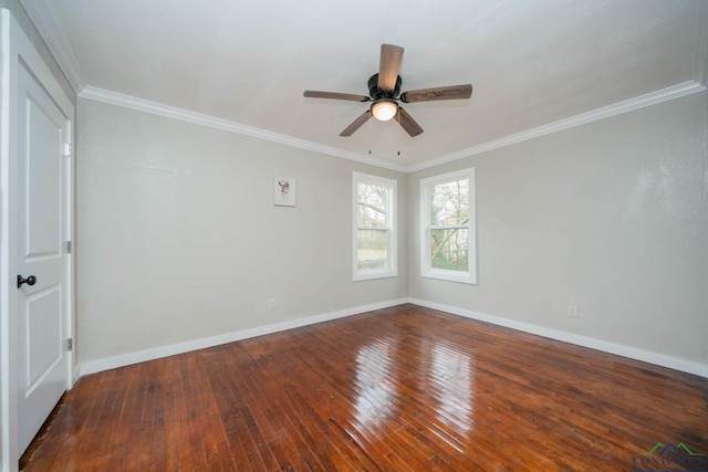 unfurnished room with crown molding, wood finished floors, and baseboards