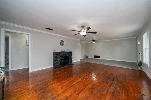 unfurnished living room with crown molding, dark wood finished floors, visible vents, and a fireplace