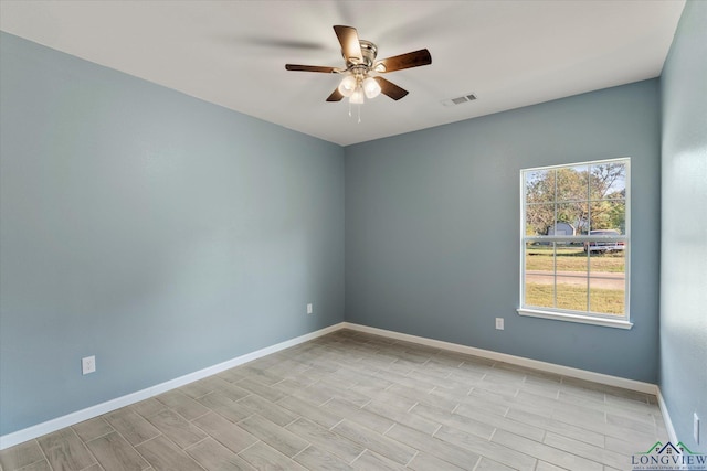 spare room with ceiling fan and light wood-type flooring