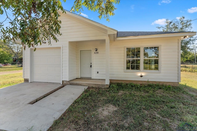 ranch-style home featuring a garage and a front yard