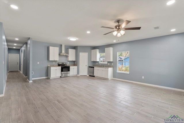 unfurnished living room featuring ceiling fan, sink, and light hardwood / wood-style flooring