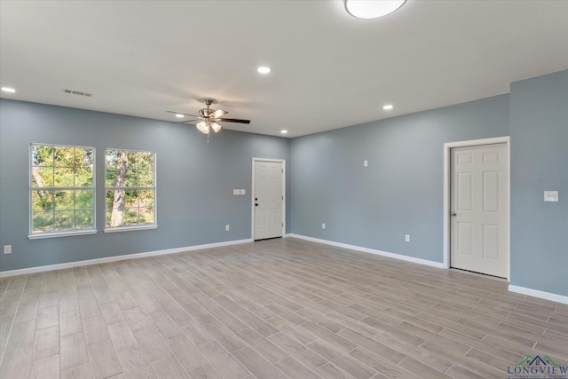 spare room with ceiling fan and light hardwood / wood-style flooring