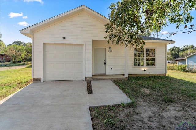 ranch-style house with a garage and a front yard