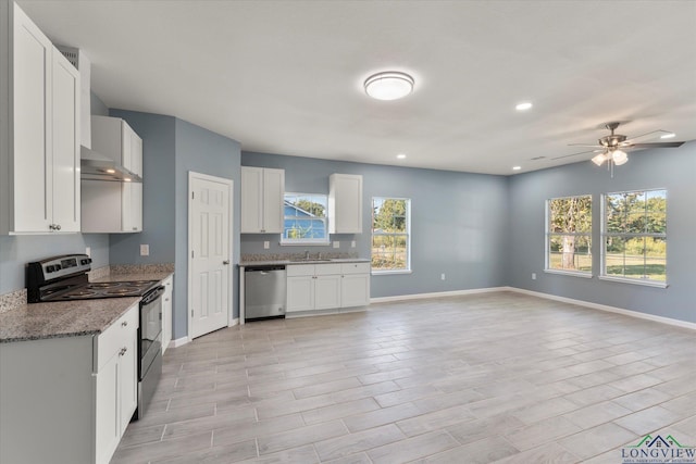 kitchen with light stone counters, ceiling fan, white cabinets, and appliances with stainless steel finishes