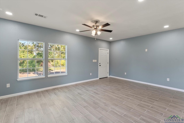 spare room featuring light hardwood / wood-style flooring and ceiling fan