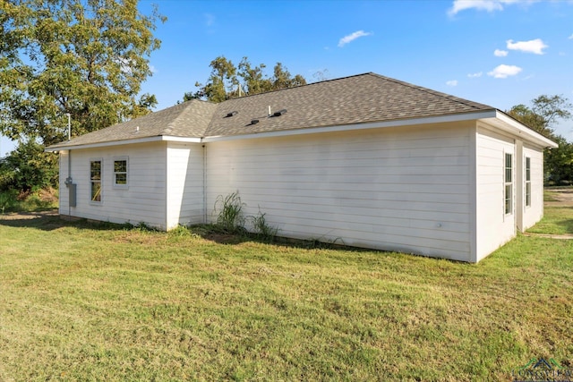 view of side of property with a yard