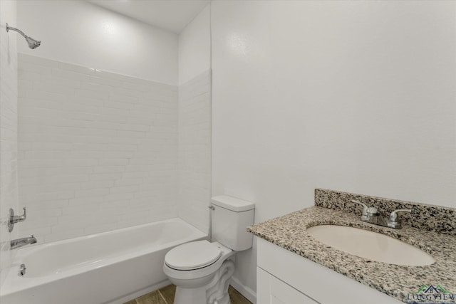 full bathroom featuring tiled shower / bath combo, vanity, and toilet