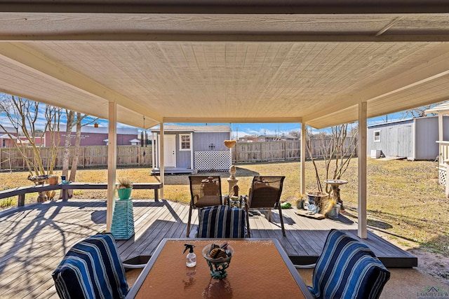 exterior space with a deck and a storage shed