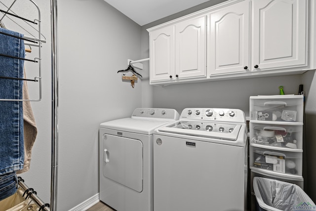 laundry room featuring cabinets and washer and dryer