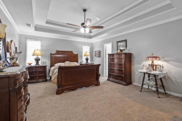 carpeted bedroom with a raised ceiling, crown molding, and ceiling fan