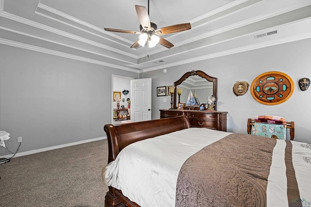 carpeted bedroom with ceiling fan, ornamental molding, and a tray ceiling