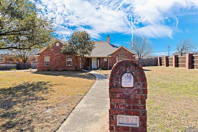 ranch-style home with a front yard