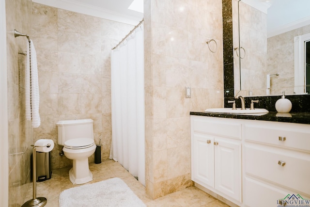 bathroom featuring tile walls, vanity, crown molding, and tile patterned flooring